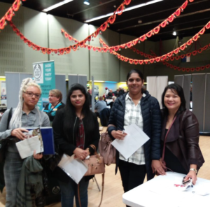 Manchester Adult Education learners networking at a jobs fair.