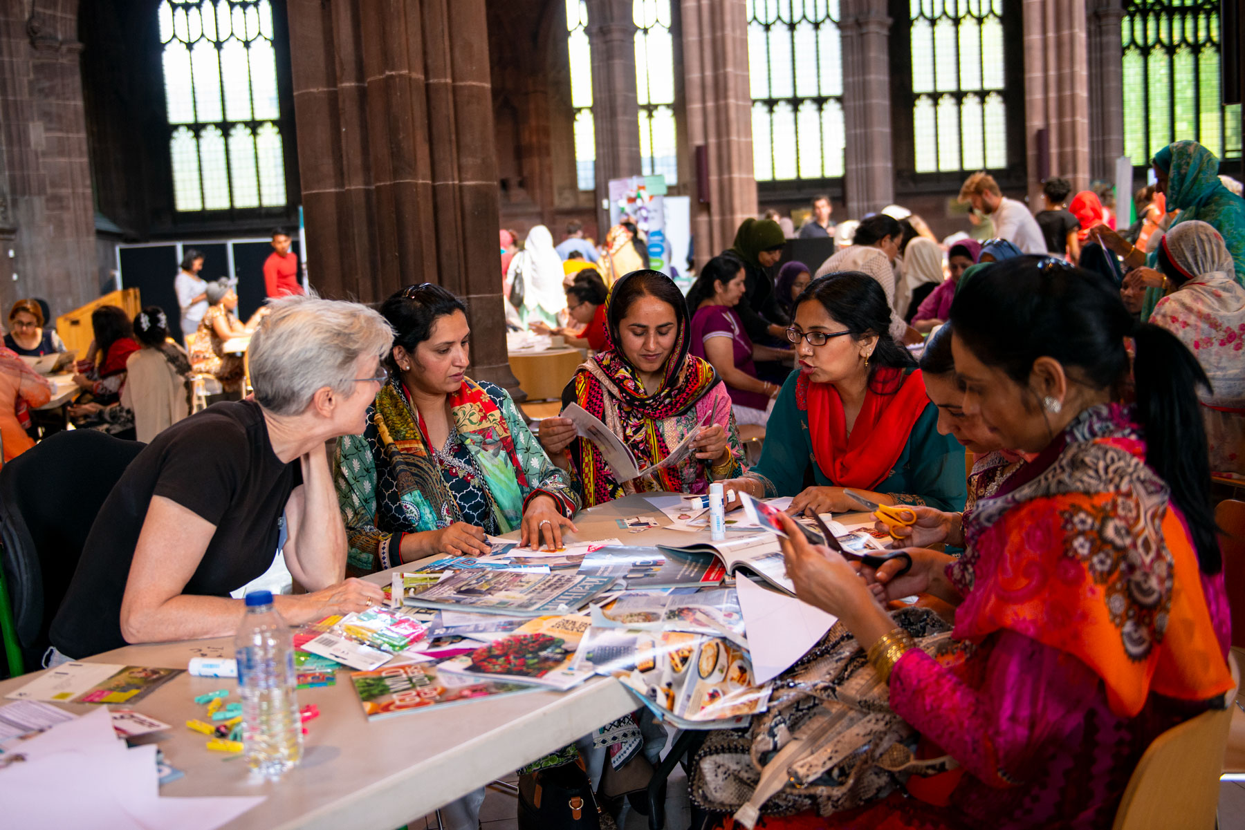 Group of people sat round a table talking