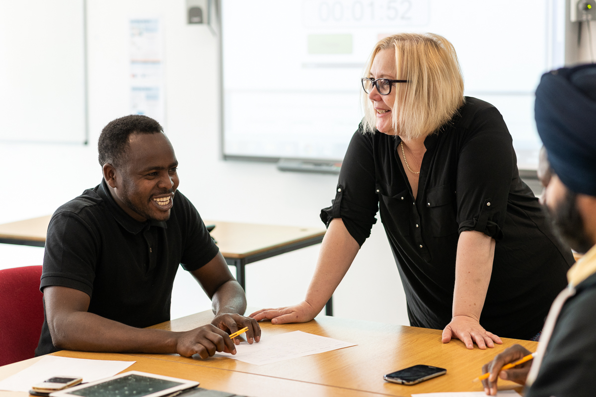 People in a classroom smiling