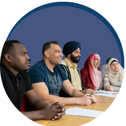 Decorative image of group of learners sat in a classroom smiling at teacher