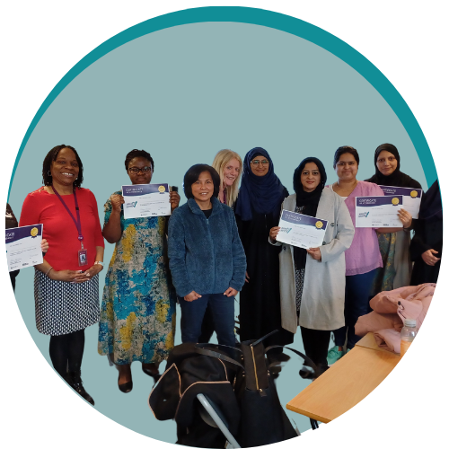 Group of women holding certificates smiling at the camera inside a green decorative circle graphic