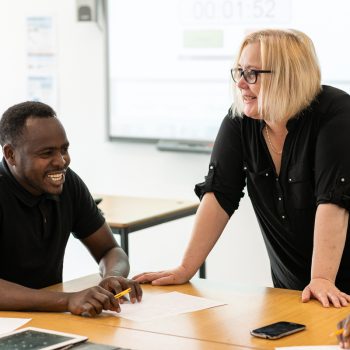 People in a classroom smiling