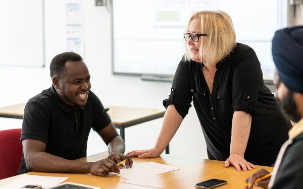 People in a classroom smiling