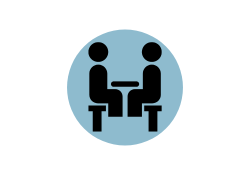 Blue circle graphic with black icon of people sitting down at a table