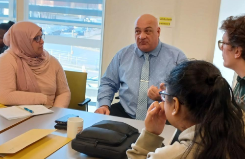 Group discussion around a table in a classroom